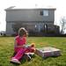 Eight-year-old Carly Judit plays with a doll in the back of her tornado-damaged home in the Huron Farms subdivision in Dexter on Monday. Judit rode out last Thursday's storm with her mom, sister and grandparents in their basement.  Melanie Maxwell I AnnArbor.com